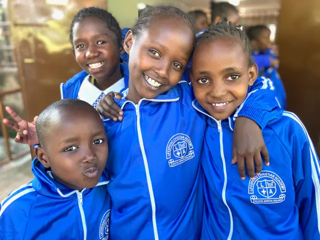4 African kids in new school uniform blue tracksuits
