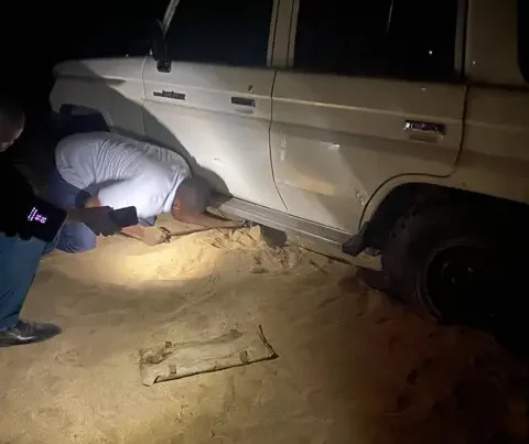 Truck Stuck in the mud while man works to find a solution