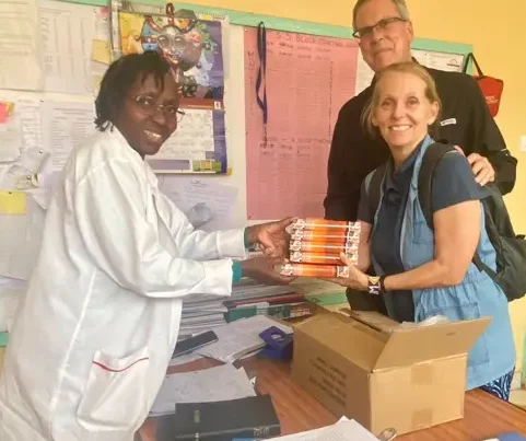 Melody and Lewis Gifting a Stack of Bibles