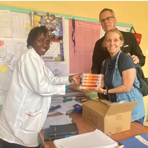 Melody and Lewis Gifting a Stack of Bibles